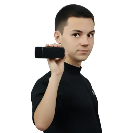A boy with a black phone in his hand.
