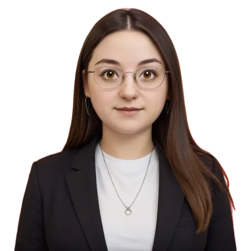 A woman wearing glasses and a blazer is standing in front of a black background.