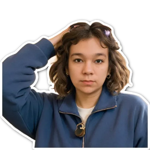 A girl is wearing a blue jacket and turning her head.