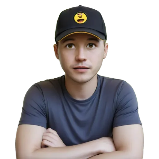 A young man wearing a blue shirt with a smiley face on a black hat.