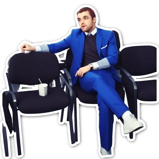 A man in a blue suit is sitting in a black chair.