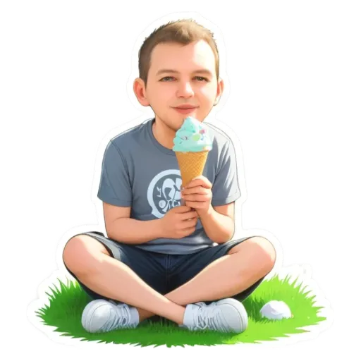 A boy is sitting in the grass and eating an ice cream cone.
