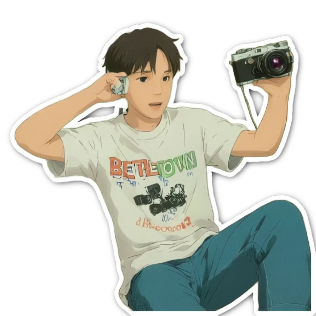 A boy with a camera holding it up to his ear is wearing a shirt that says 'bedown'.